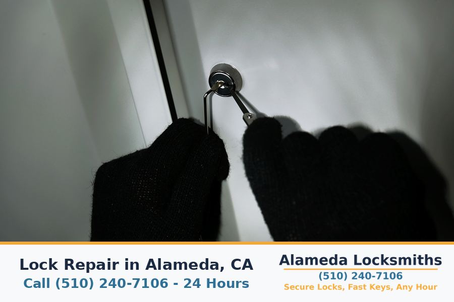 Locksmith repairing a door lock mechanism with hand tools