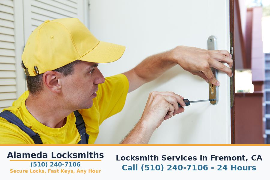 Locksmith working on a residential door lock in Fremont, CA